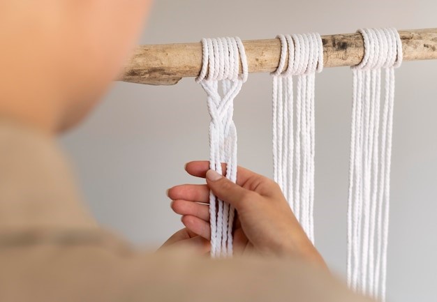 Merangkai macrame wall hanging. 